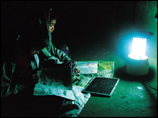 A girl reading in the dark with a lantern. A girl reading in the dark with a lantern.