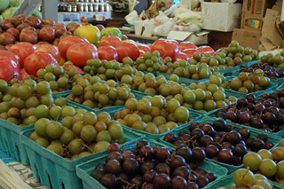 A photograph of produce at a farmers market. A photograph of produce at a farmers market.