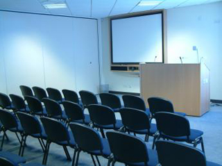 A photo of an empty lecture room. A photo of an empty lecture room.