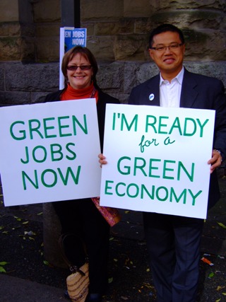 People with signs supporting a green economy. People with signs supporting a green economy.