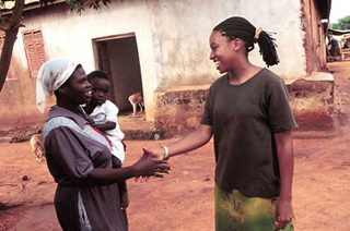 A volunteer and a local shake hands. A volunteer and a local shake hands.