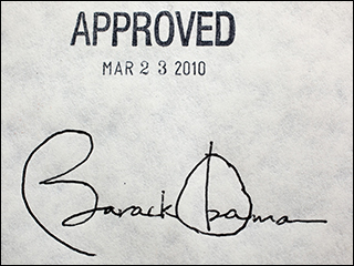 A photograph of a piece of paper, with President Barack Obama's signature at the bottom and a stamp above it that reads "APPROVED MAR 23 2010." A photograph of a piece of paper, with President Barack Obama's signature at the bottom and a stamp above it that reads "APPROVED MAR 23 2010."