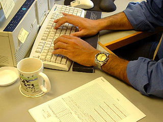 Hands typing on a keyboard. Hands typing on a keyboard.
