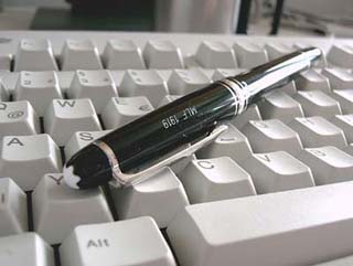 Photograph of pen and computer keyboard. Photograph of pen and computer keyboard.