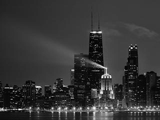 A black and white photo of the Chicago skyline at night. A black and white photo of the Chicago skyline at night.