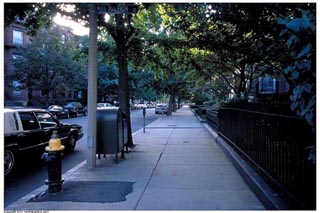 A photo looking down a wide sidewalk. A photo looking down a wide sidewalk.