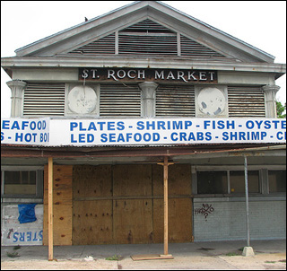 A photograph of a dilapidated abandoned market that used to sell produce and seafood. A photograph of a dilapidated abandoned market that used to sell produce and seafood.