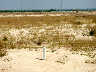 White boundary stones in an arid landscape, marking the boundary between public and private land. White boundary stones in an arid landscape, marking the boundary between public and private land.