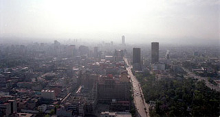 An aerial photo of the Mexico City skyline with haze in the distance. An aerial photo of the Mexico City skyline with haze in the distance.
