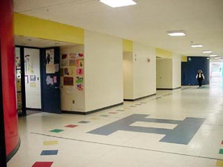 A photo of a wide school hallway. A photo of a wide school hallway.