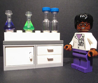 Chemistry equipment and a female African-American scientist are depicted in a Lego® set. Chemistry equipment and a female African-American scientist are depicted in a Lego® set.