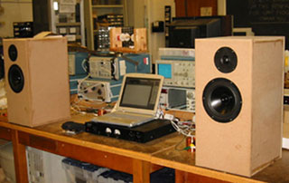 A photo of a laptop connected to a pair of custom speakers. A photo of a laptop connected to a pair of custom speakers.
