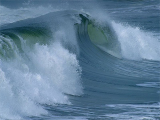 A photograph of an ocean wave cresting. A photograph of an ocean wave cresting.