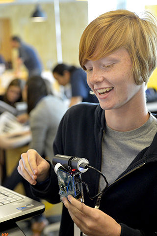 A photograph of a girl holding parts of a programmable camera as part of the Girls Who Build Cameras workshop. A photograph of a girl holding parts of a programmable camera as part of the Girls Who Build Cameras workshop.