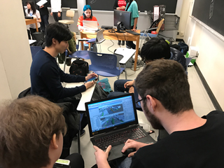 A photo of students working on computers in a classroom. A photo of students working on computers in a classroom.