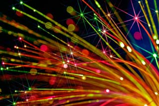 Photograph of the ends of fiber optic fibers lit by a red LED. Photograph of the ends of fiber optic fibers lit by a red LED.